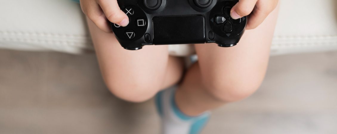 high-angle-little-boy-holding-controller-close-up