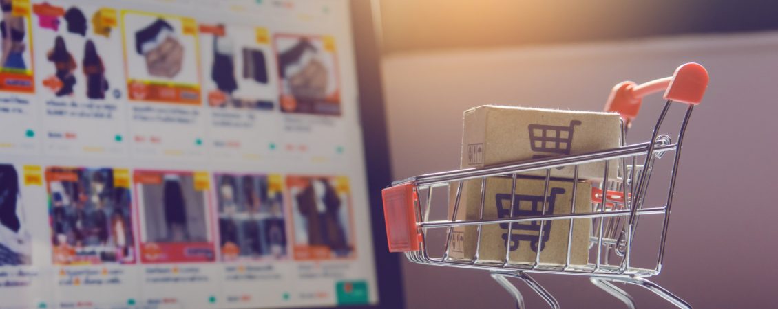 parcel-or-paper-cartons-with-shopping-cart-logo-in-trolley-on-laptop-keyboard