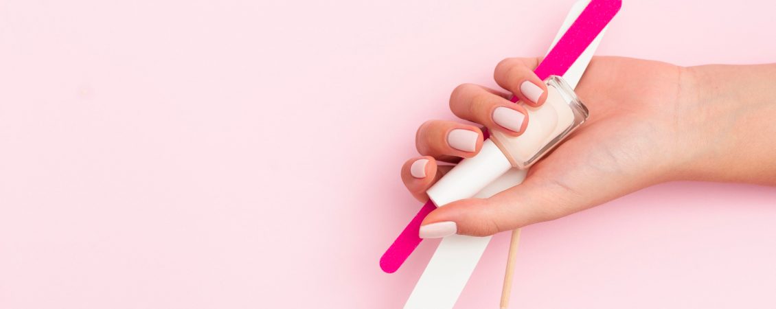 woman-holding-manicure-tools-with-copy-space
